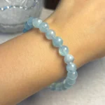 model wearing aquamarine bracelet for calm and emotional ease