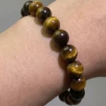 model wearing tiger’s eye bracelet for courage and grounding