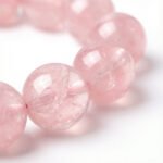 close-up of rose quartz beads symbolizing heart chakra energy