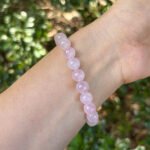 rose quartz bracelet lifestyle photo in soft romantic lighting