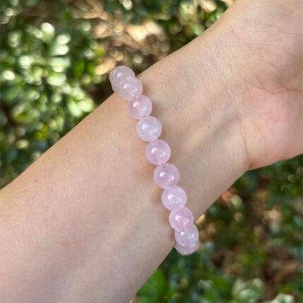 rose quartz bracelet lifestyle photo in soft romantic lighting