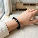 model wearing black obsidian bracelet for grounding and protection