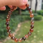 Copper Rutilated Quartz Bracelet close-shot under natural light