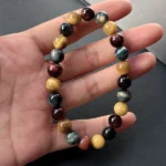 Model holding Tigers Eye Trio Bracelet