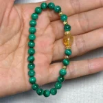 model holding Steady Growth Bracelet