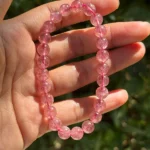 model holding Strawberry Quartz Bracelet