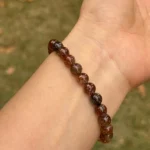 model wearing Copper Rutilated Quartz Bracelet close-shot bottom view