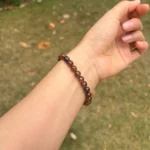 model wearing Copper Rutilated Quartz Bracelet far bottom view