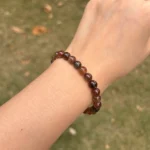 model wearing Copper Rutilated Quartz Bracelet far view