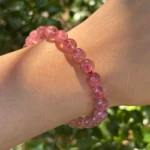 model wearing Strawberry Quartz Bracelet in shadow front view