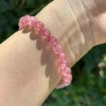 model wearing Strawberry Quartz Bracelet under natural light bottom view