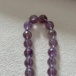 Faceted round amethyst under natural light